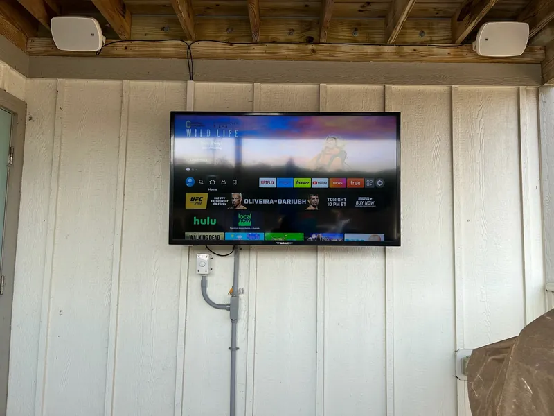 Outdoor television and speakers installed at a beach property.