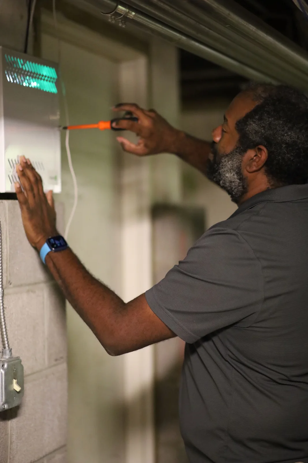 FM Tech technician working on electronic equipment at a customer facility.